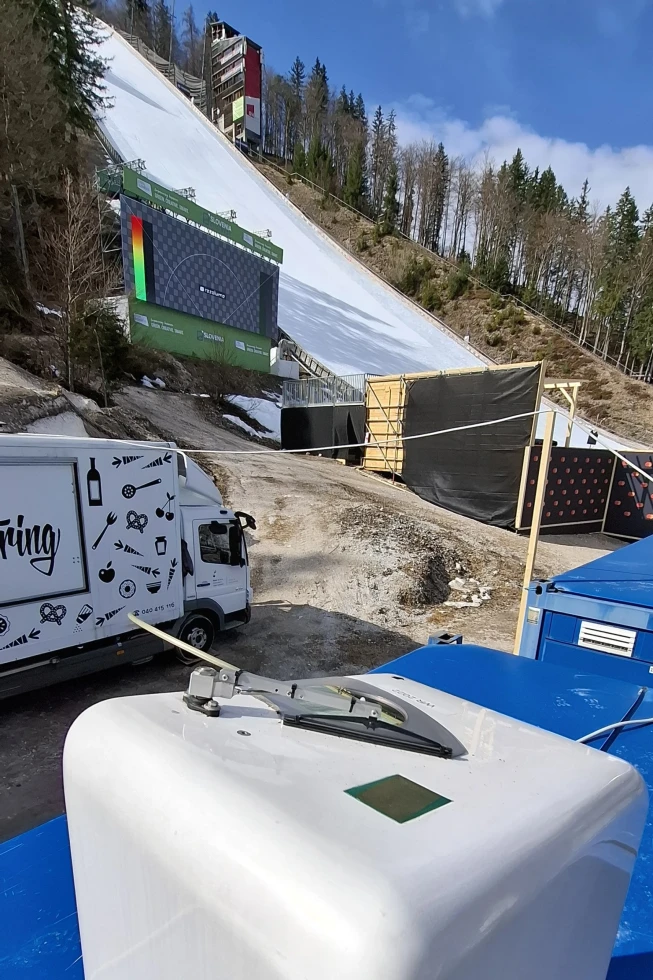 Pozicioniranje naprave, zadaj se vidi sneg na letalnici.