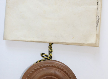 The seal and casket are attached with a black-and-yellow braided cord.
