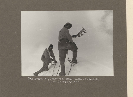 Members of Slovenian Himalayan expedition planting a flag on top of the mountain.