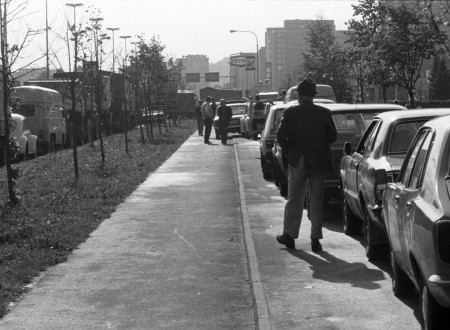 Black-and-white photograph of a queue at a gas station.