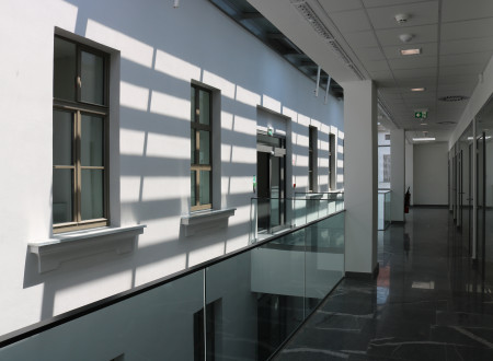 A play of light - the sun streams through the roof blinds and casts shadows on the old barracks façade.