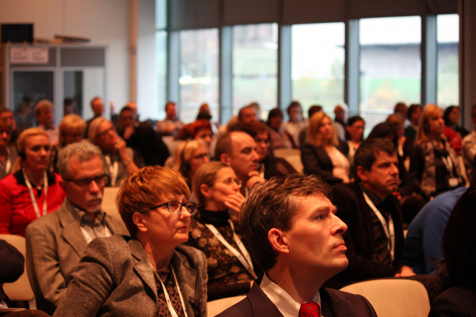 Visitors of the conference sitting in the conference hall.