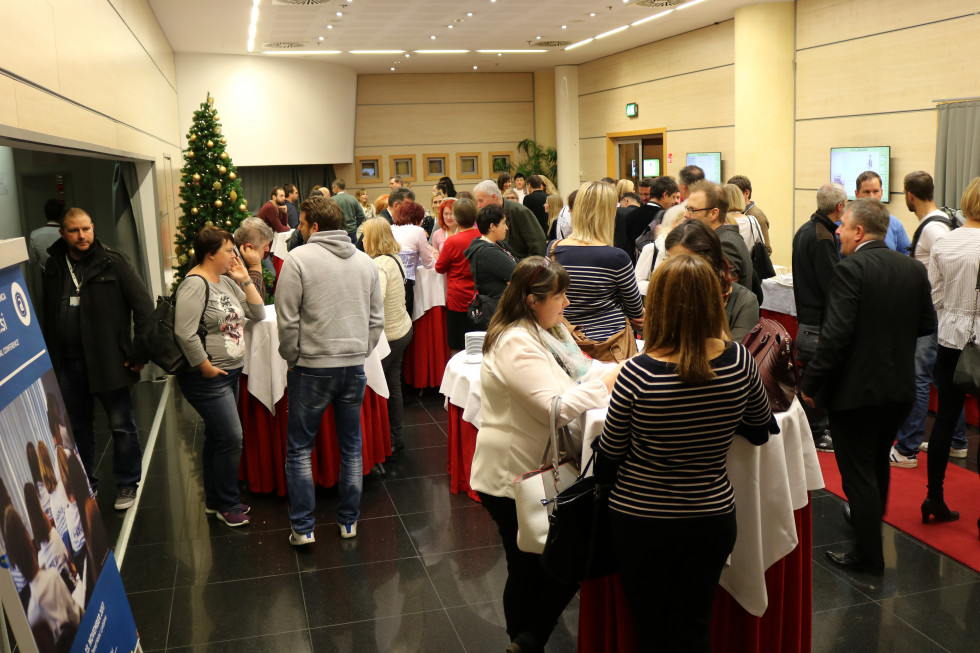 Visitors of the conference sitting in the conference hall.