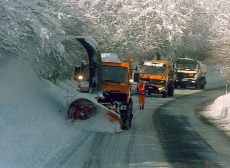 Vozila zimske službe pri pluženju ceste na Pokljuko.