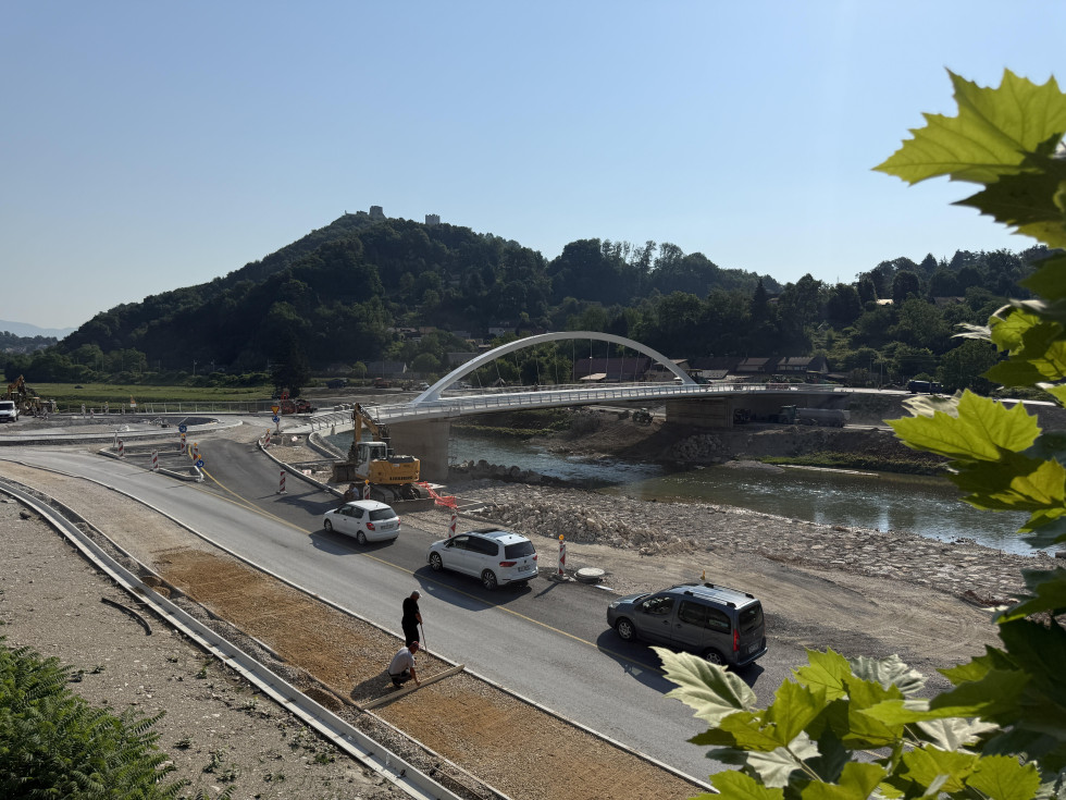 Gradnja novega mostu čez reko, v ospredju avtomobili, ter nova cesta in rondo, ki vodita do mostu