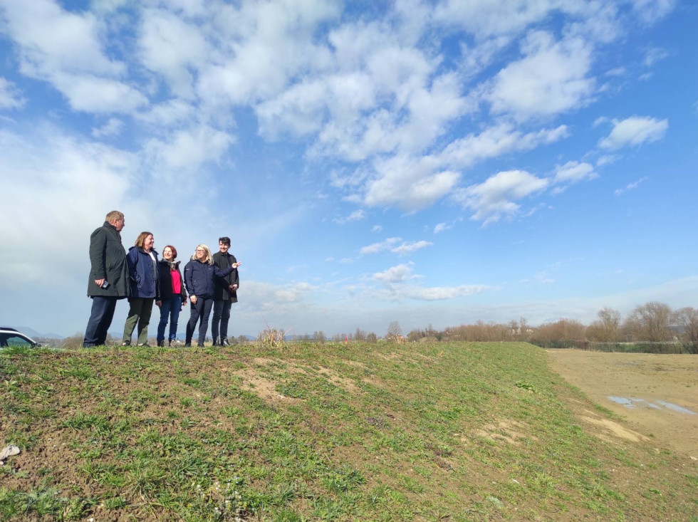 People standing on high-water embankment.