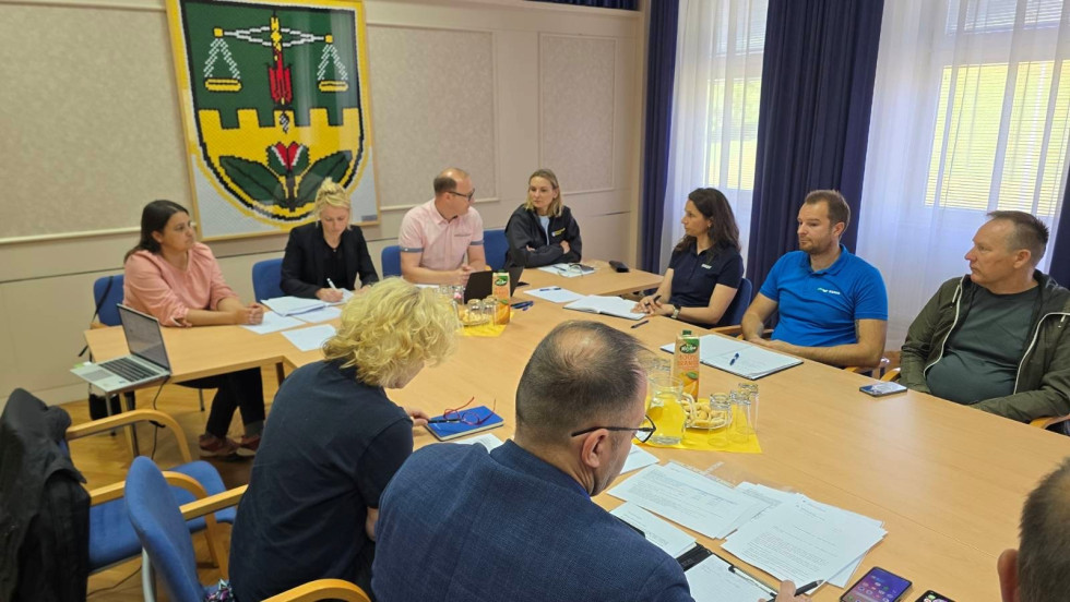 Minister's meeting with the local community, sitting around the table.