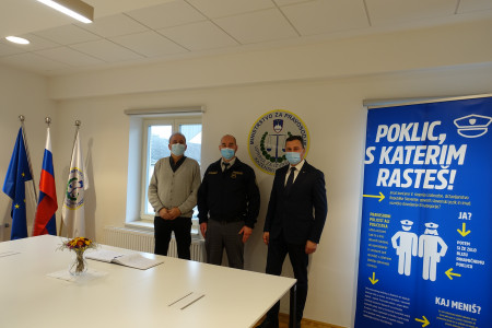 Skupinska fotografija, v ozadju plakat s sloganom "Poklic, s katerim rasteš."
