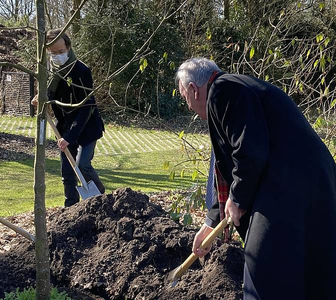 Dr Genorio planting the bee tree.