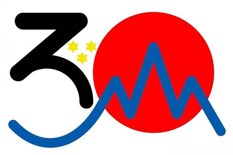 The logo includes the number 30, together with the Japanese and Slovene motives of the red sun and Mt. Triglav