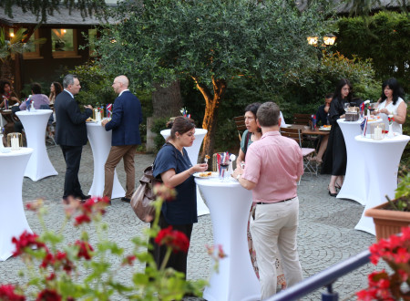 Guests mingle in the hotel garden following the formal programme of the reception.