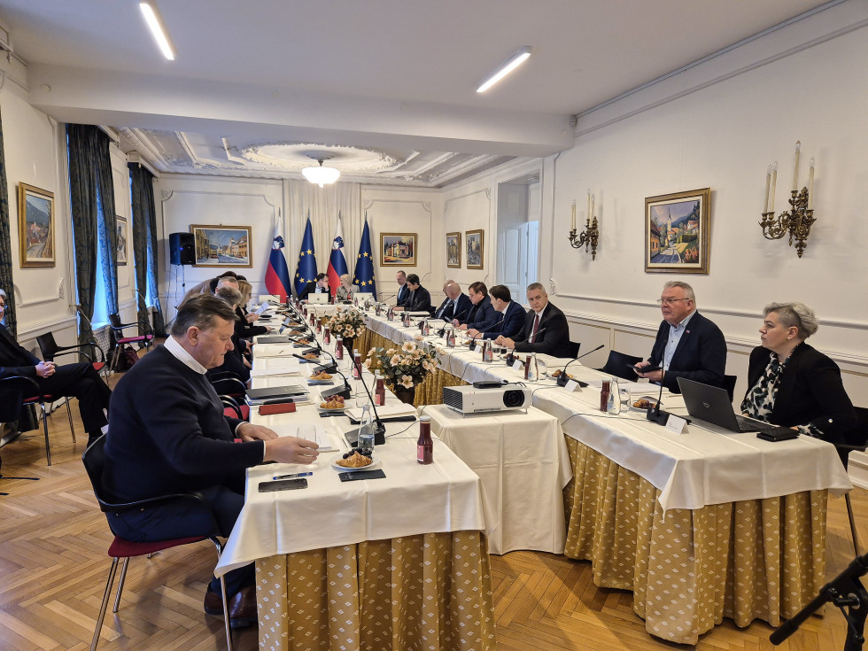 people sitting at a long table in a hall