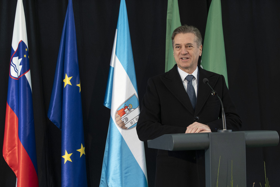 A man is standing behind a lectern.