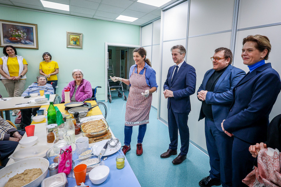 A group of people are gathered in a nursing home