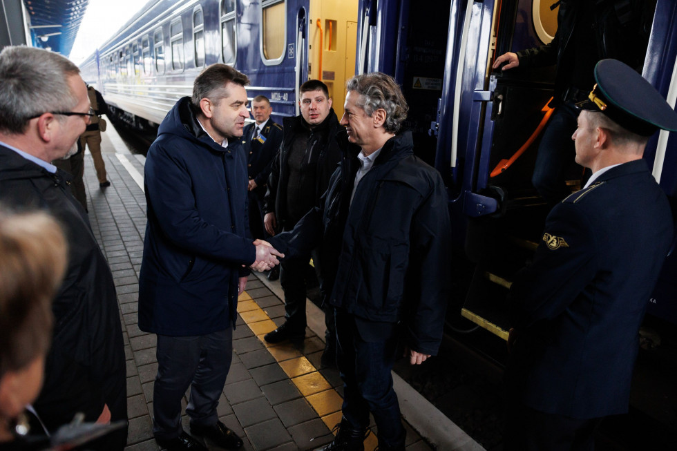 Prime Minister Robert Golob and his delegation arrive in Kiev. A train is seen in the background.