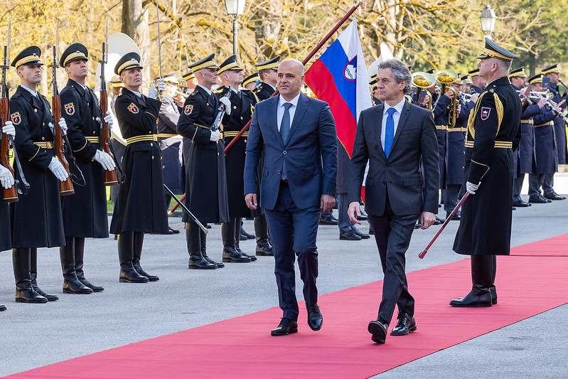 Prime Ministers Robert Golob and Dimitar Kovačevski walk past the guard of honour