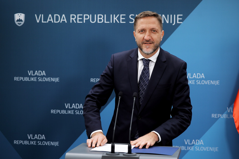 The minister is standing at the podium