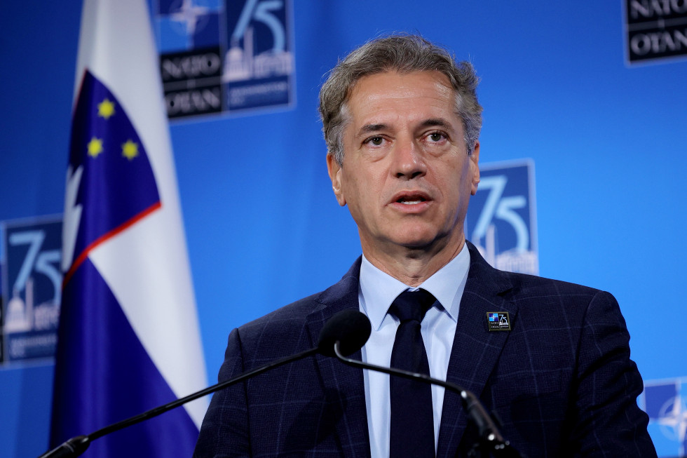 The Prime Minister, Dr Robert Golob, makes a statement. In the background is the Slovenian flag and the NATO logo