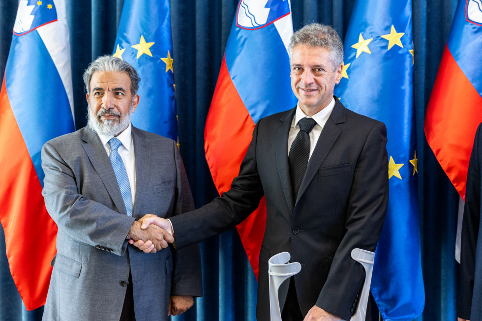 Prime Minister Robert Golob shakes hands with the Qatari Minister of Endowments and Islamic Affairs