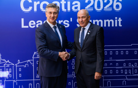 PV na MED9 Split 1 07102026 (Janez Janša and Andrej Plenković shake hands, with banners bearing the symbols of the MED9 Summit in the background.)