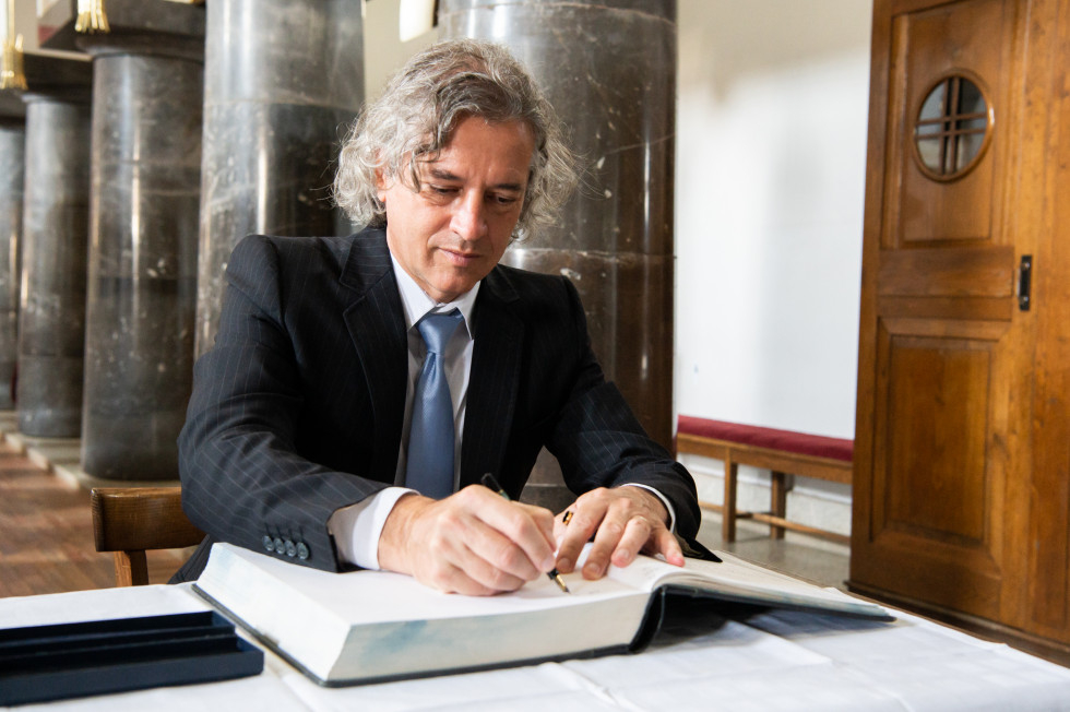 The Prime Minister is signing in the guest book