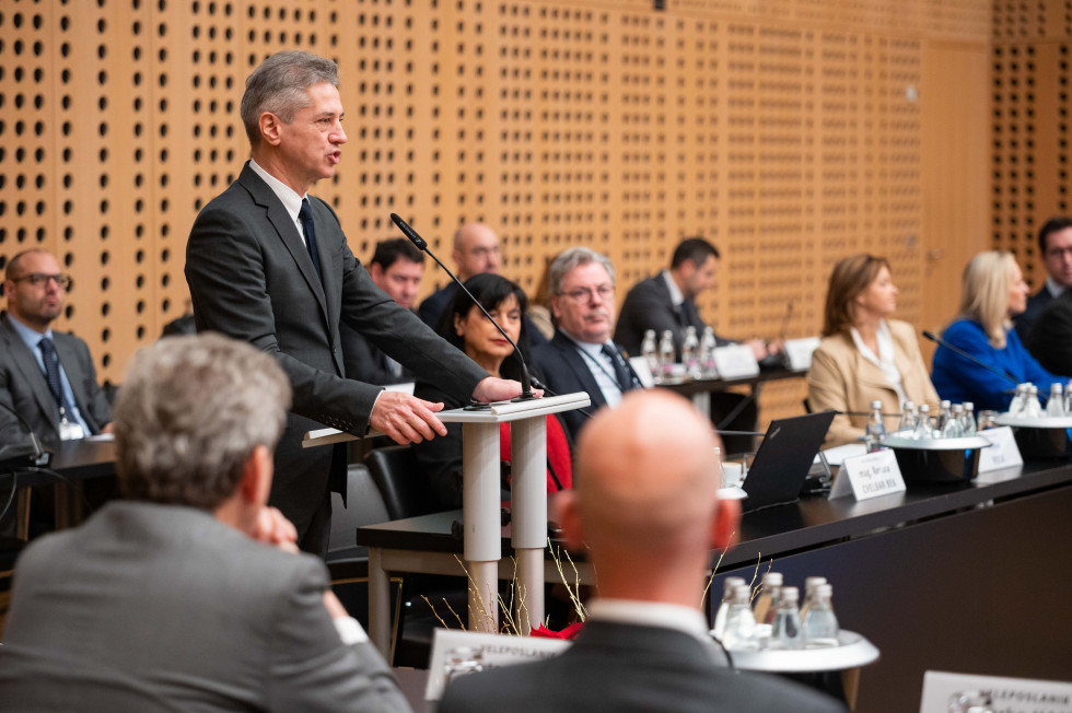 Prime Minister speaks at the lectern among the meeting participants