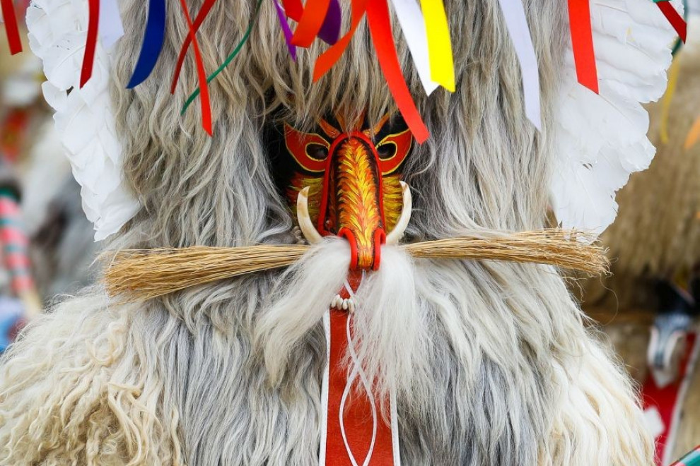 The kurent, who resembles a demon, is clothed in sheepskin, and around his belt hang large cowbells and beautifully embroidered handkerchiefs