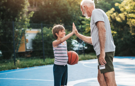 dan slovenskega sporta (High five between a child and a man)