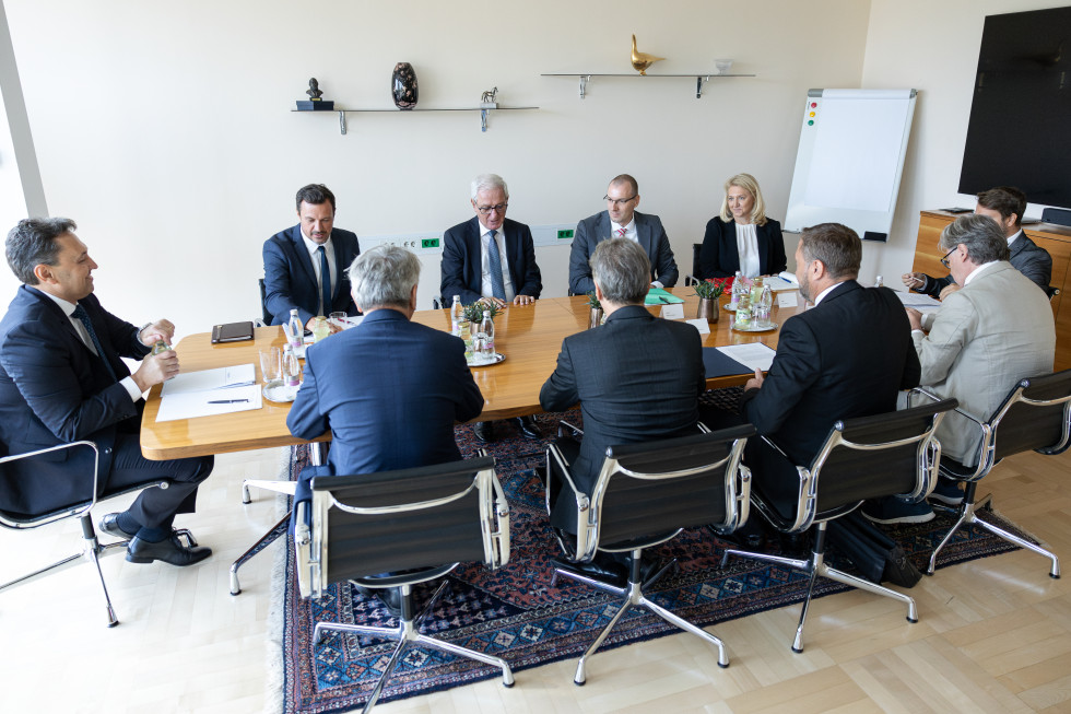 Prime Minister is sitting at the table with representatives of the Novartis company