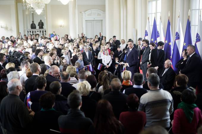 predsednik republike med množico obiskovalcev v veliki dvorani predsedniške palače