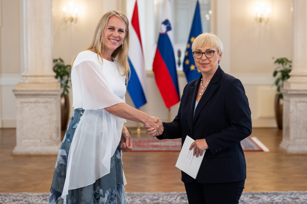veleposlanica s predsednico pred zastavami