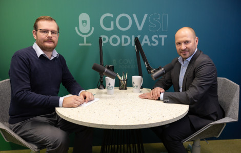 UKLS2696 (Two men are seated at a round table with two microphones, with the words "GOVSI Podcast" displayed in the background.)
