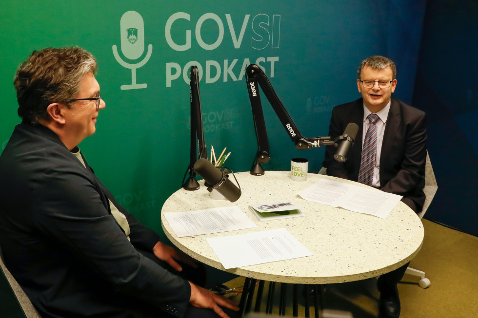 Two men sitting at a table and talking.