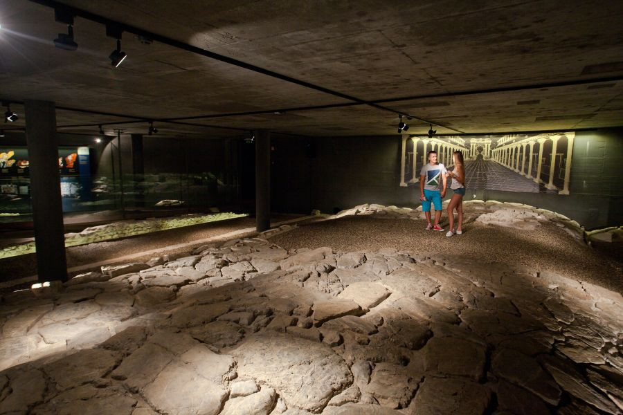 The Roman Road in the museum is viewed by two visitors.