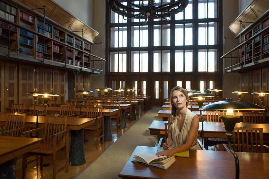 A girl sitting in National and Univesity Library of Slovenia.