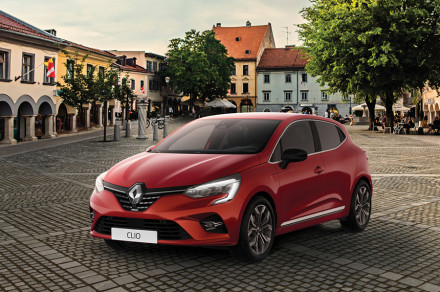 A red car is parked in the square.