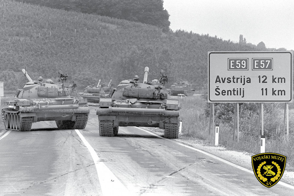 anks on the road, traffic sign with inscription Austria 12 km, Šentilj 11 km.