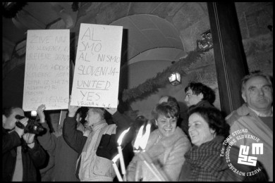 People with torches and signs.