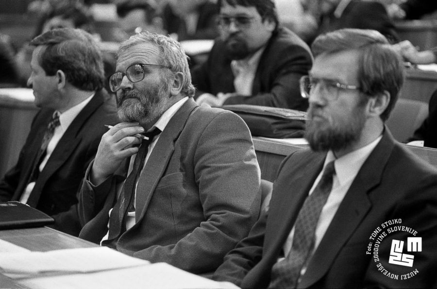 Assembly members sit in the chamber. Lojze Peterle in the foreground.