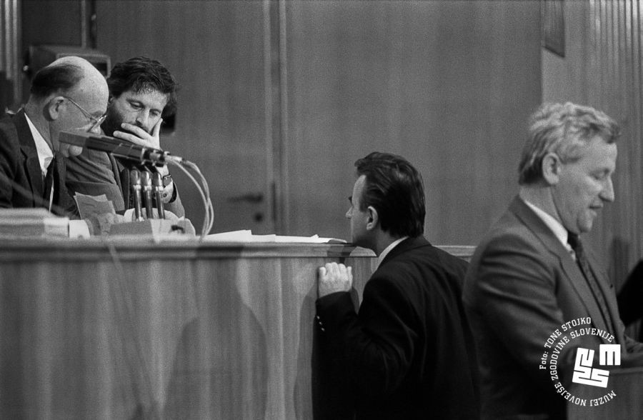 A member of the Assembly approached France Bučar, who sits on the speaker's stage. 