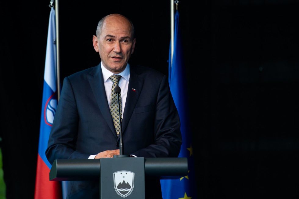 Janez Janša speaks behind the speaker's desk.